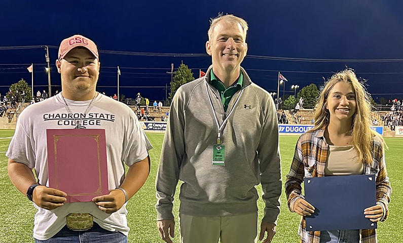 Muliti-Activity Scholarship recipients (L to R) Chase Isenbart, Chancellor Paul Turman and Haley Holzfaster